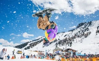 Snowboarder snowboarding at snowbombing festival 